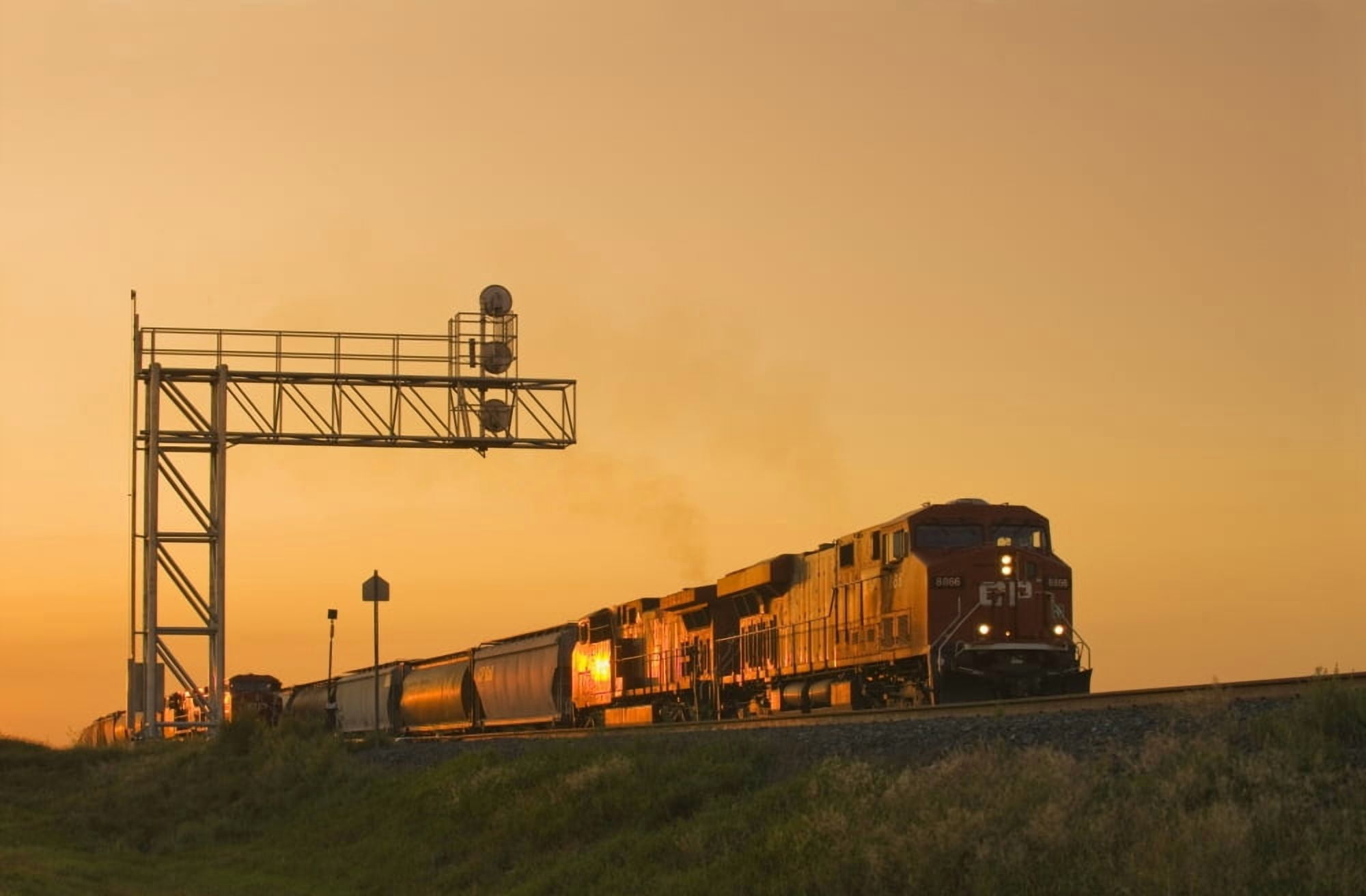 Locomotives Pulling Rail Hopper Cars Pass An Overhead Rail Signal Near Dunmore Alberta Canvas Art - Dave Reede Design Pics (36 x 22)