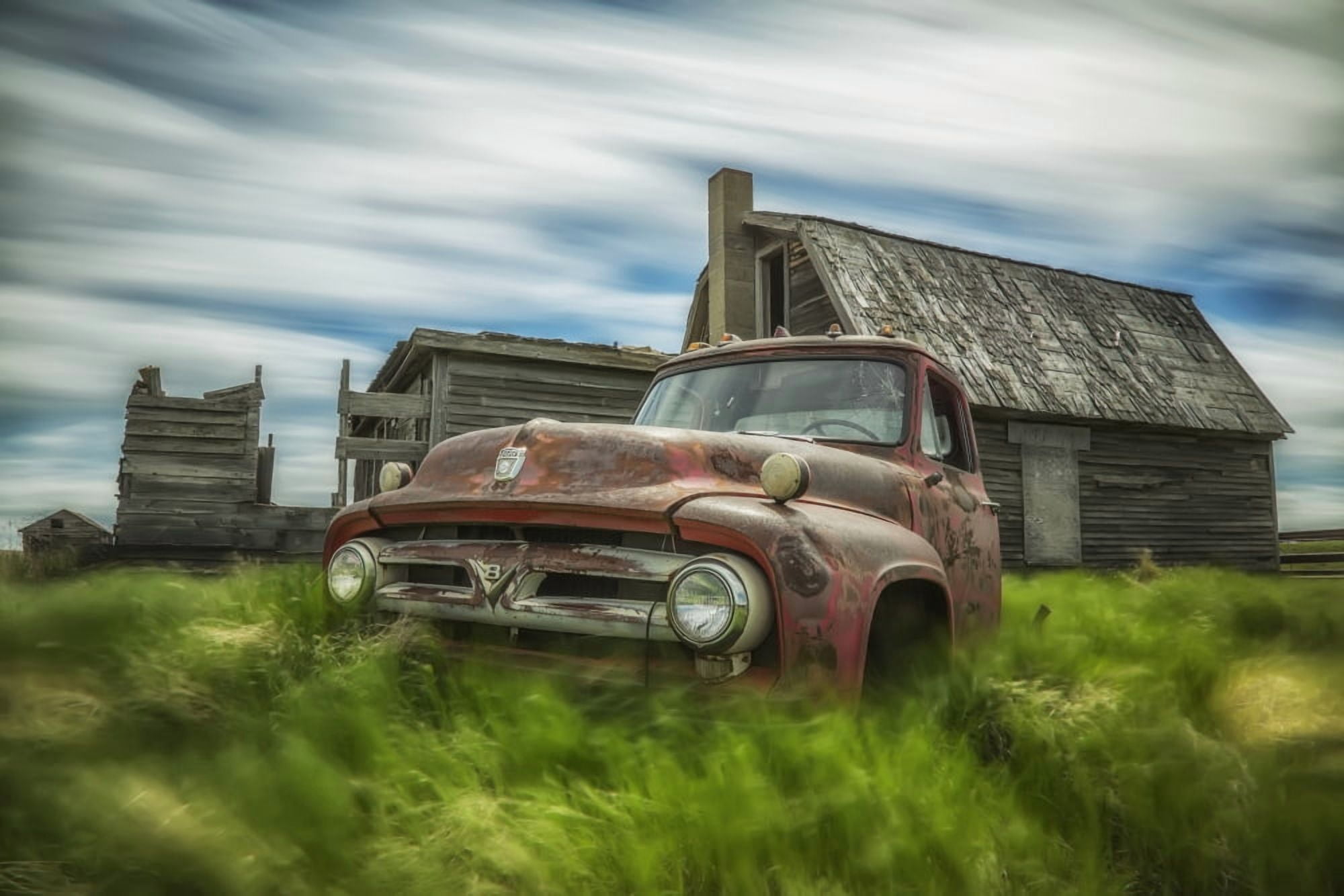 Long exposure of clouds drifting by over an abandoned truck and house in a rural area Saskatchewan Canada Canvas Art - Robert Postma Design Pics (19 x 12)