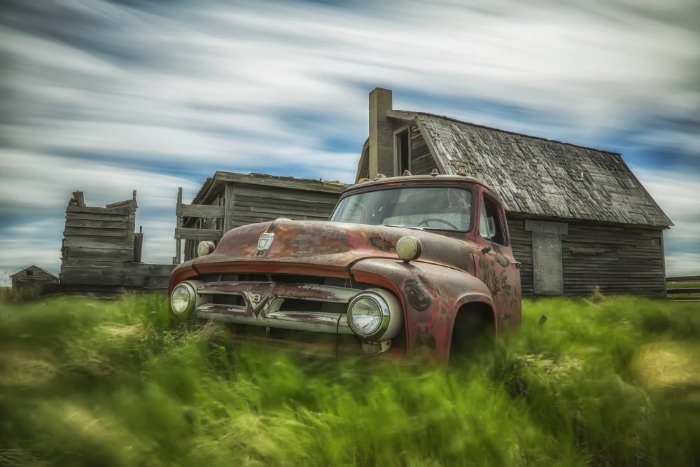 Long exposure of clouds drifting by over an abandoned truck and house in a rural area Saskatchewan Canada Canvas Art - Robert Postma Design Pics (38 x 24)