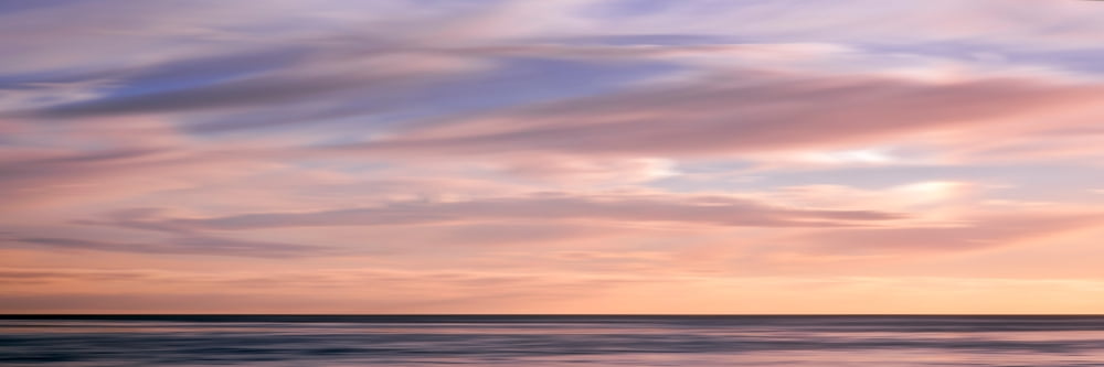 Long exposure of clouds over Pacific ocean at sunset La Jolla San Diego San Diego County California USA Canvas Art - Panoramic Images (12 x 36)