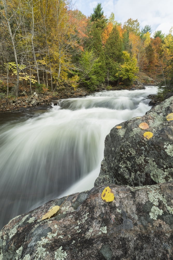 Long exposure of water flowing down Kawagama falls in the autumn near Dorset Ontario Canada Canvas Art - Robert Postma Design Pics (12 x 19)
