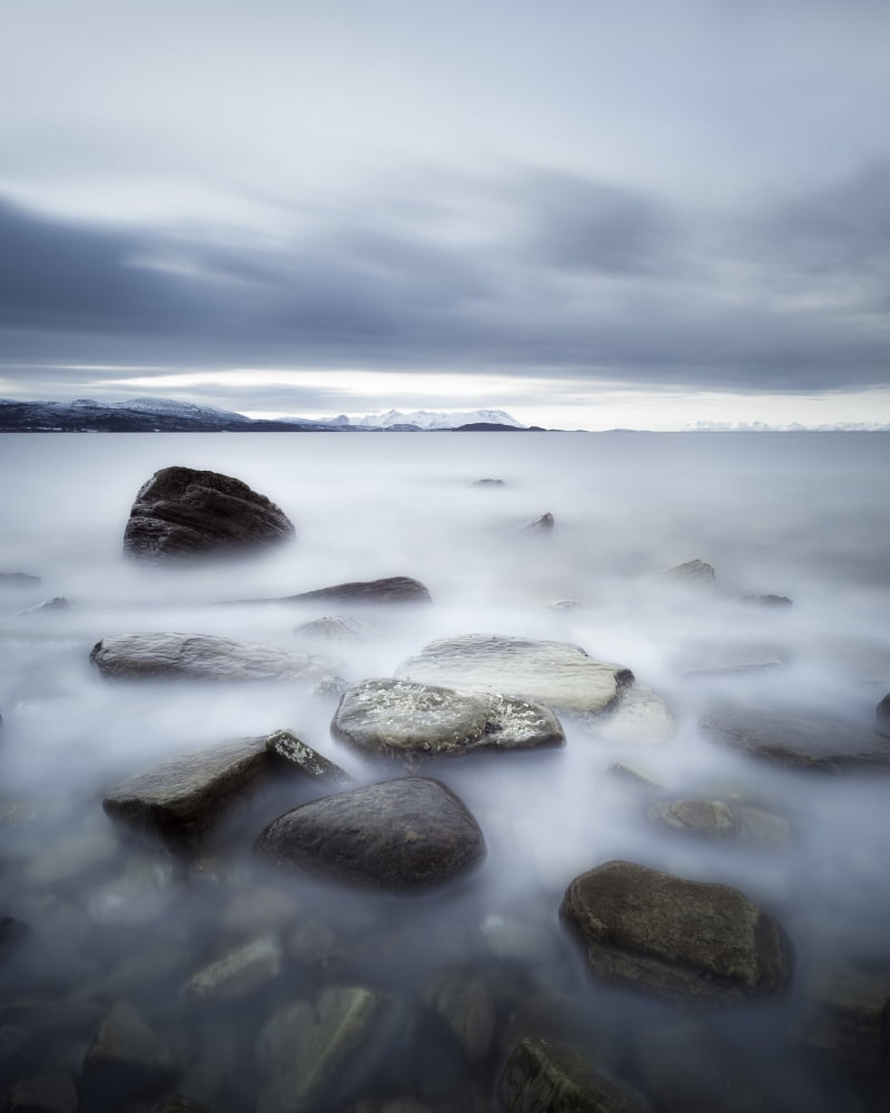 Long exposure scene of rocks in Vaagsfjorden fjord Norway Canvas Art - Arild HeitmannStocktrek Images (13 x 16)
