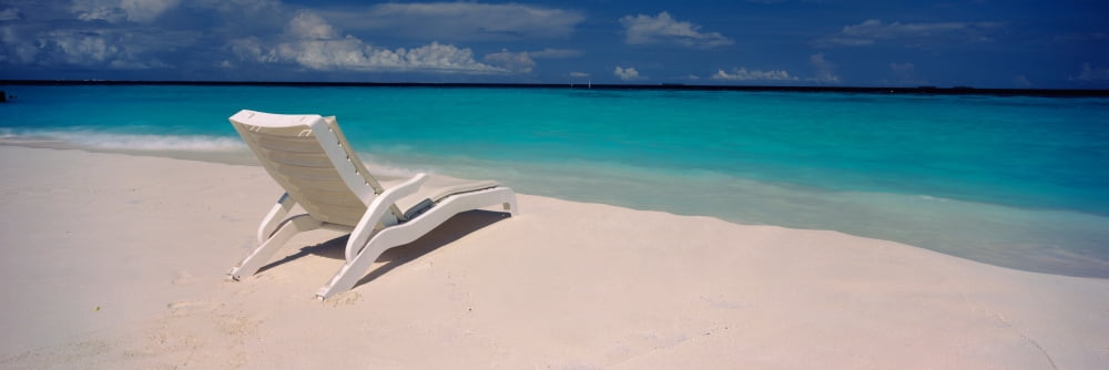 Lounge chair on the beach Thulhagiri Island Resort North Male Atoll Maldives Canvas Art - Panoramic Images (27 x 9)