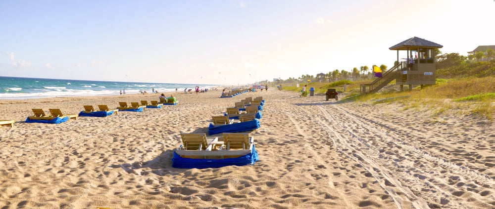 Lounge chairs and lifeguard hut on the beach Delray Beach Palm Beach County Florida USA Canvas Art - Panoramic Images (27 x 9)