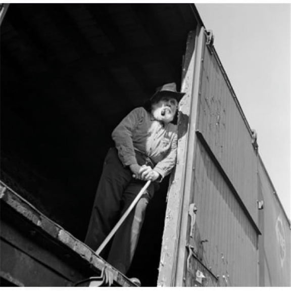 Low Angle View of a Senior Man Standing in a Train Car Poster Print - 18 x 24 in.