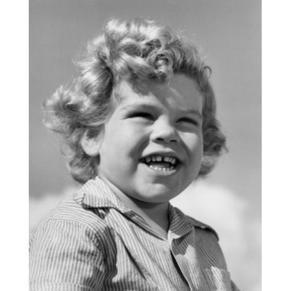 Low-angle portrait of boy smiling in bright sunlight Canvas Art - (24 x 36)