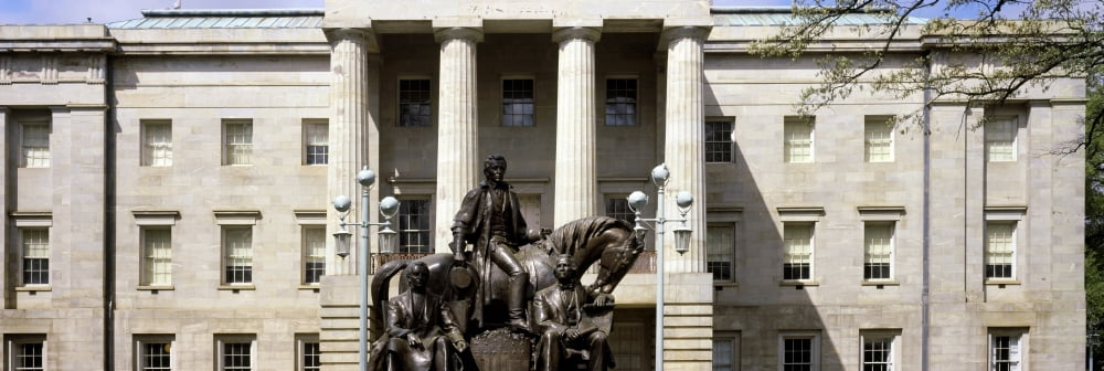 Low angle view of Statue with a government building in the background North Carolina State Capitol Raleigh North Carolina USA Canvas Art - Panoramic Images (36 x 12)