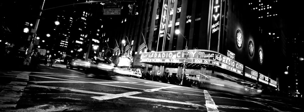 Low angle view of buildings lit up at night Radio City Music Hall Rockefeller Center Manhattan New York City New York State USA Canvas Art - Panoramic Images (7 x 18)