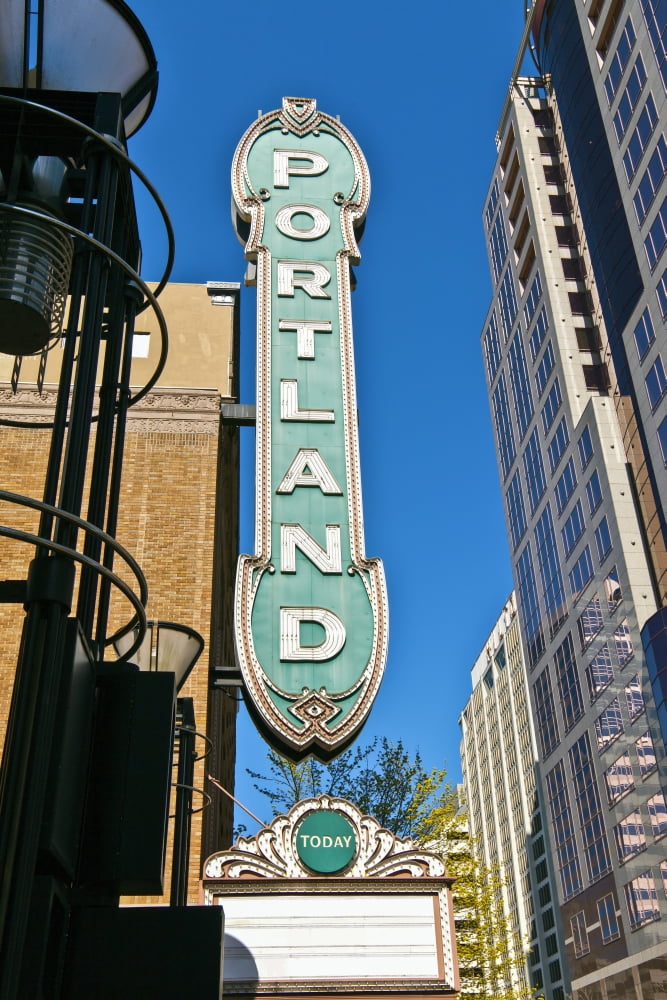 Low angle view of Portland landmark sign and modern skyscrapers Portland Oregon USA Canvas Art - Panoramic Images (36 x 12)