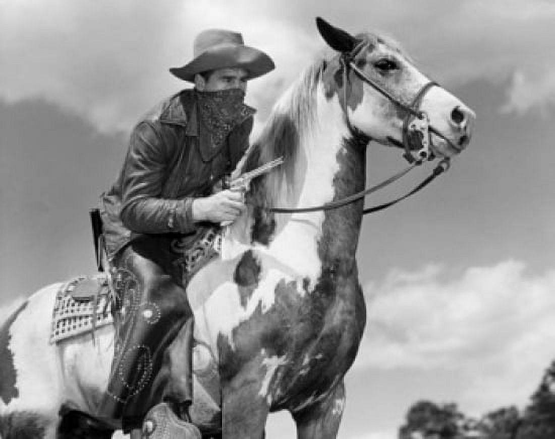 Low angle view of a bandit holding a gun while sitting on a horse Canvas Art - (24 x 36)