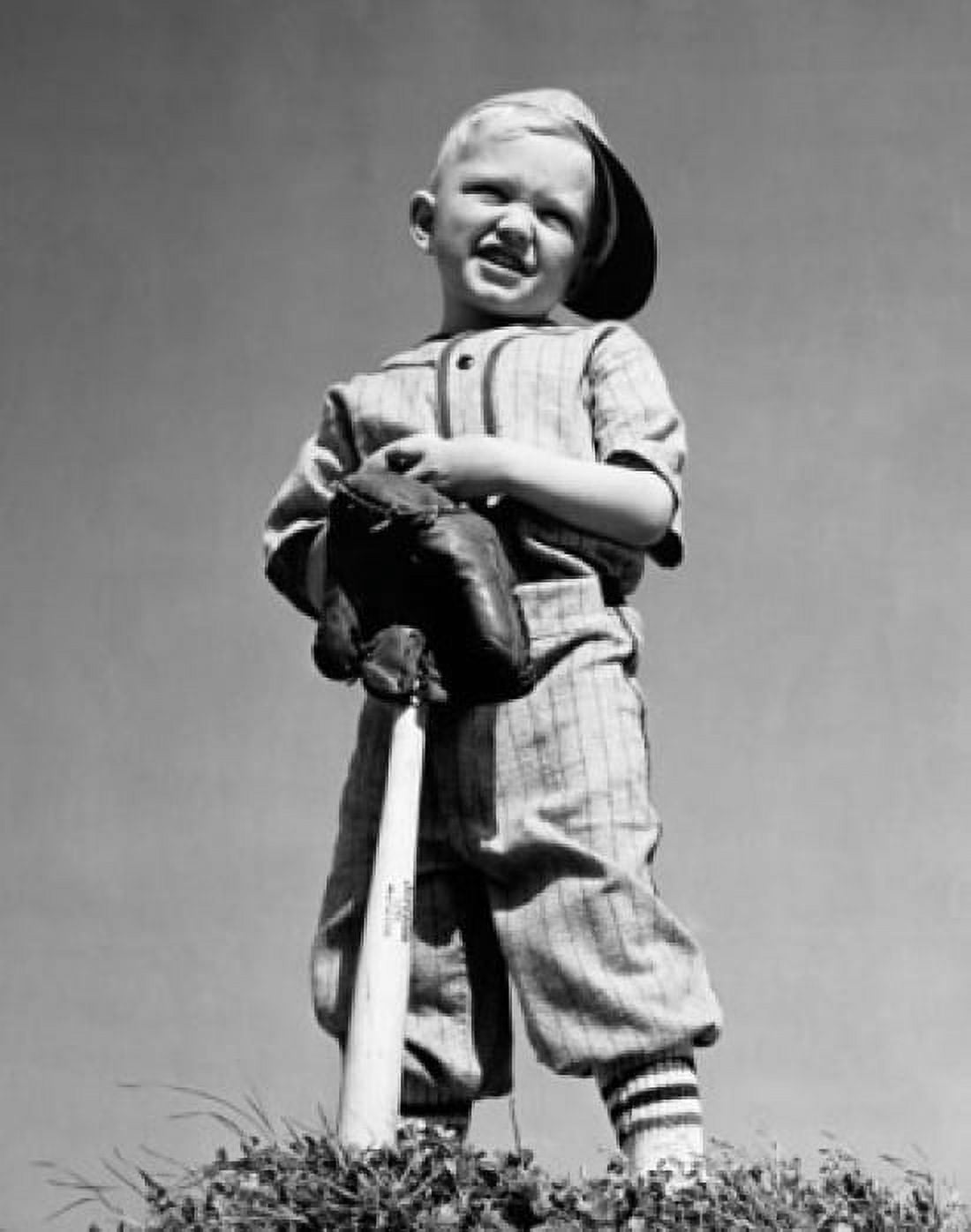 Low angle view of a boy holding a baseball bat and squinting Canvas Art - (18 x 24)