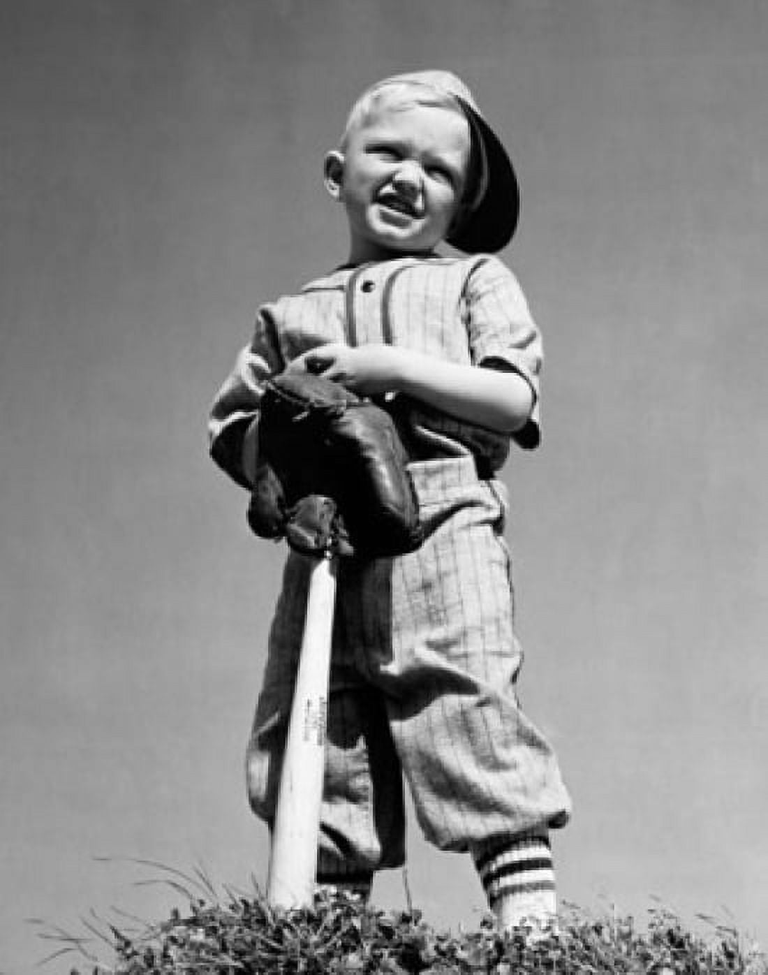 Low angle view of a boy holding a baseball bat and squinting Canvas Art - (24 x 36)