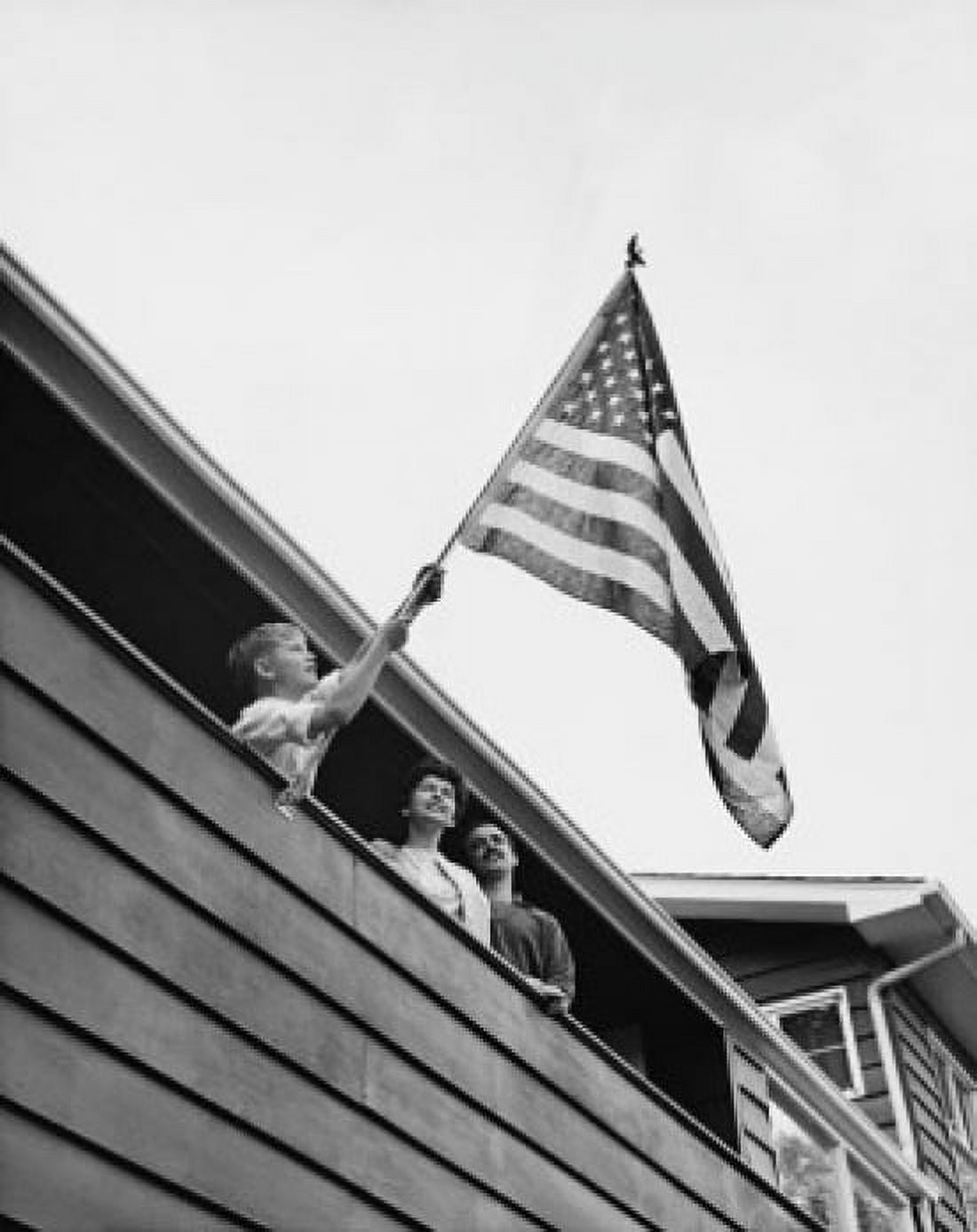 Low angle view of a boy holding an American flag USA Canvas Art - (18 x 24)