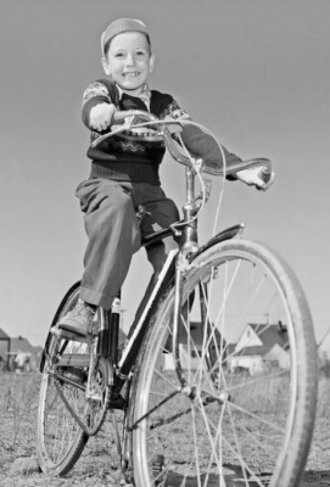 Low angle view of a boy riding a bicycle Canvas Art - (24 x 36)