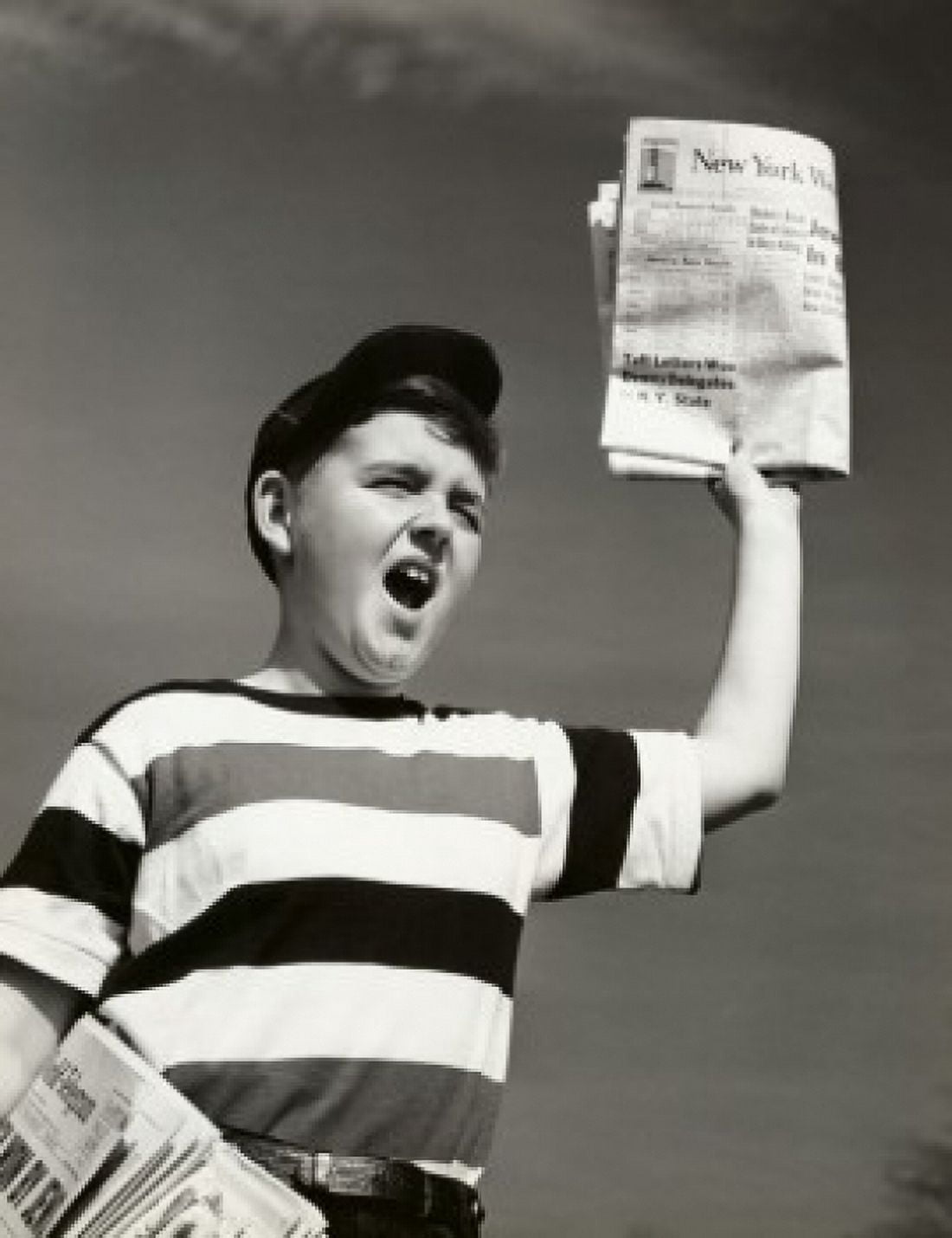Low angle view of a boy selling newspapers Canvas Art - (18 x 24)