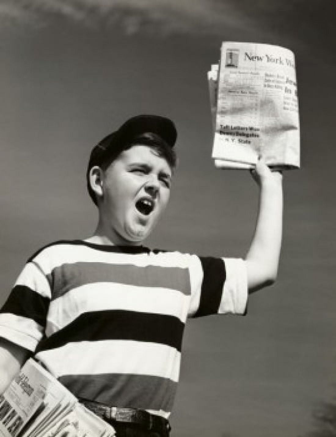 Low angle view of a boy selling newspapers Canvas Art - (24 x 36)