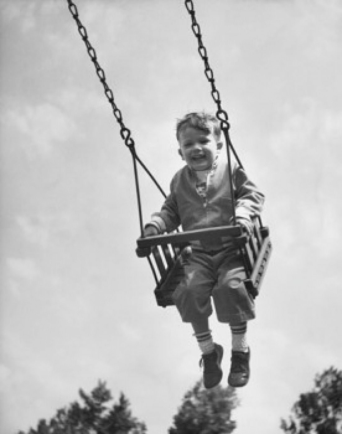 Low angle view of a boy swinging on a swing Canvas Art - (24 x 36)