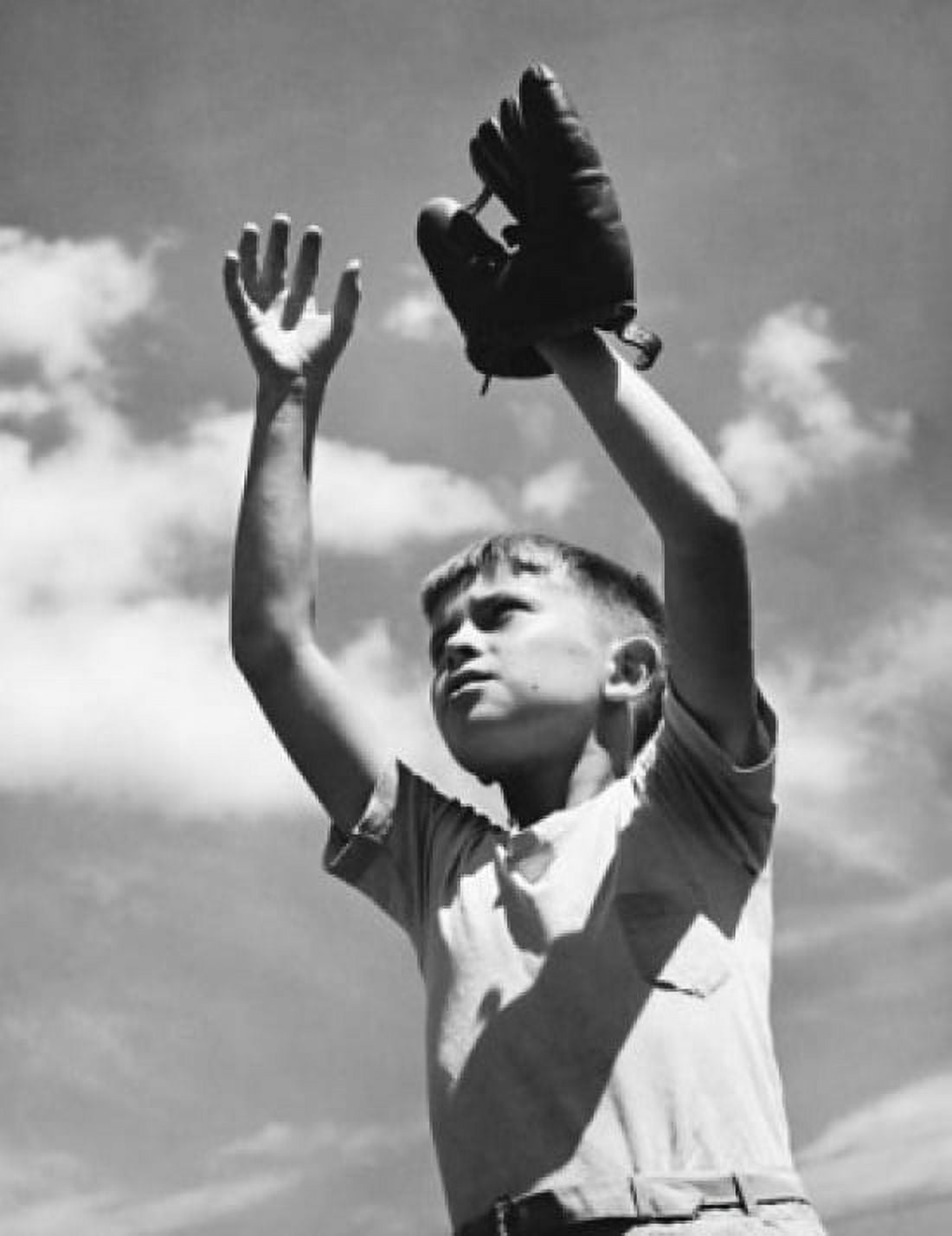 Low angle view of a boy wearing a baseball glove with his arms raised Canvas Art - (18 x 24)