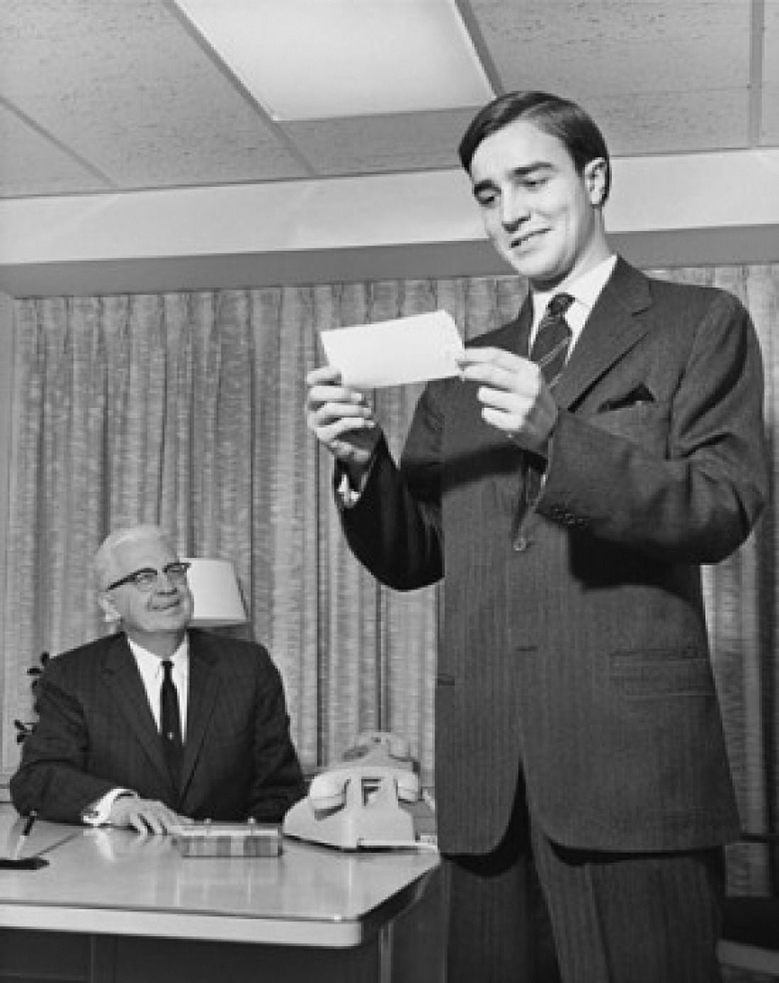 Low angle view of a businessman looking at a check Canvas Art - (24 x 36)