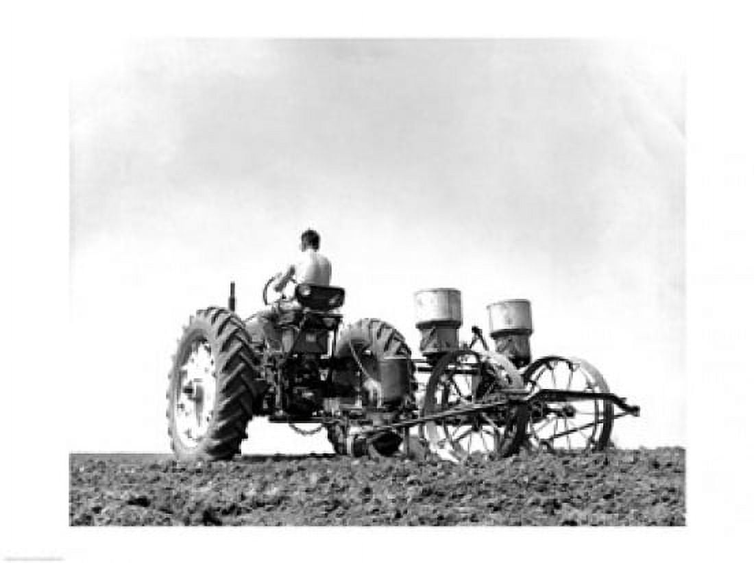 Low angle view of a farmer planting corn with a tractor in a field Canvas Art - (18 x 24)