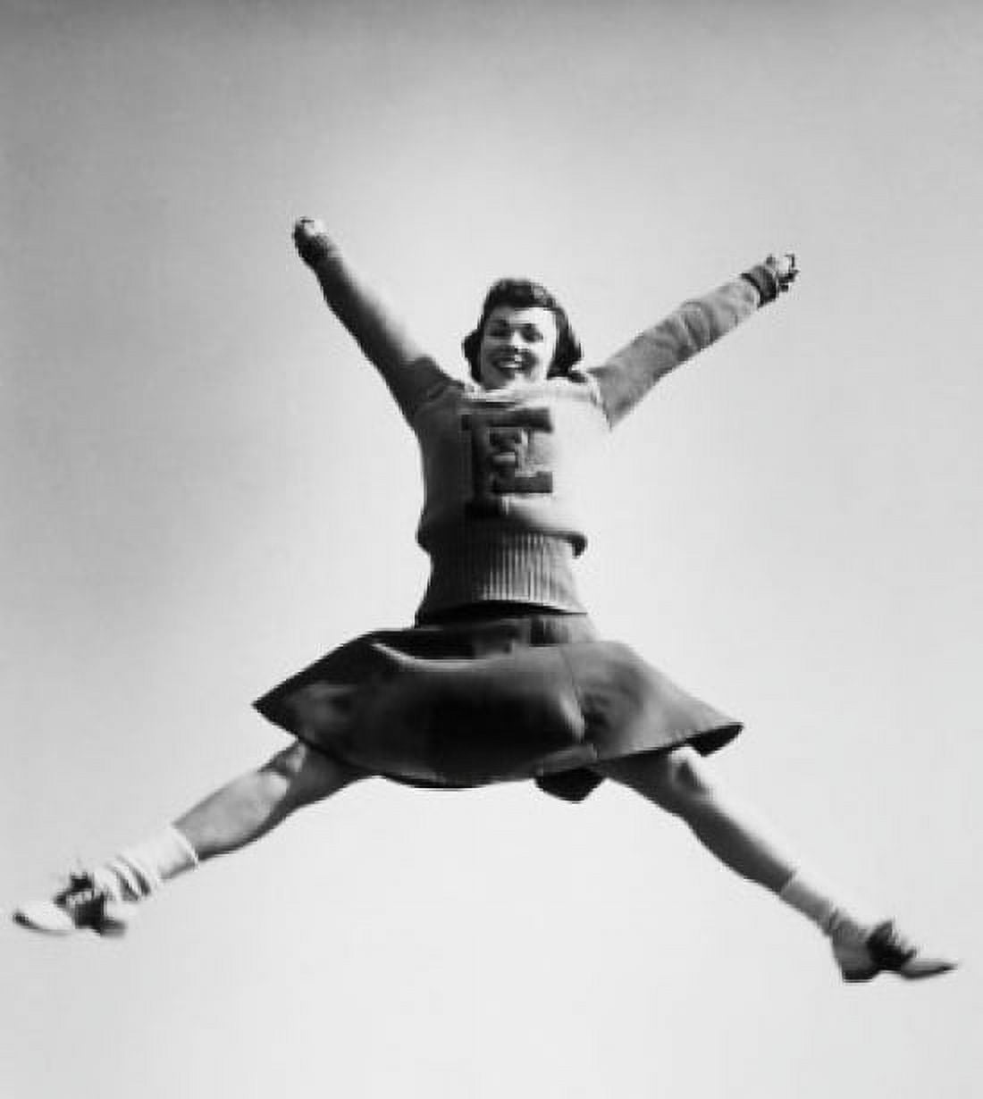 Low angle view of a female cheerleader jumping Canvas Art - (24 x 36)