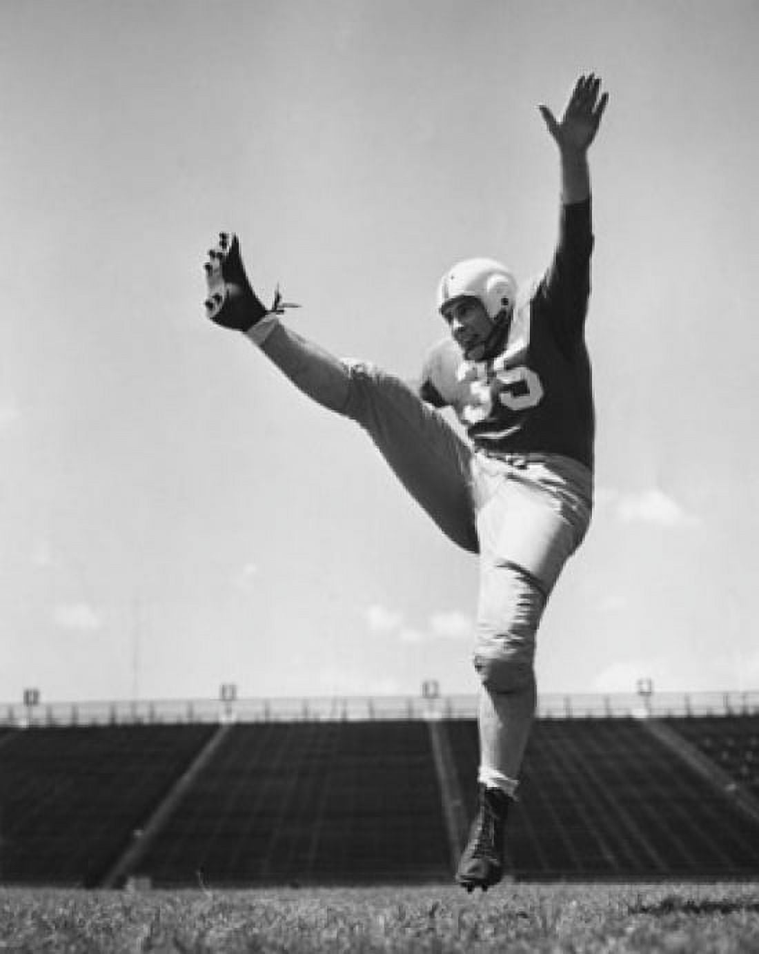 Low angle view of a football player practicing kicking in a stadium Canvas Art - (18 x 24)