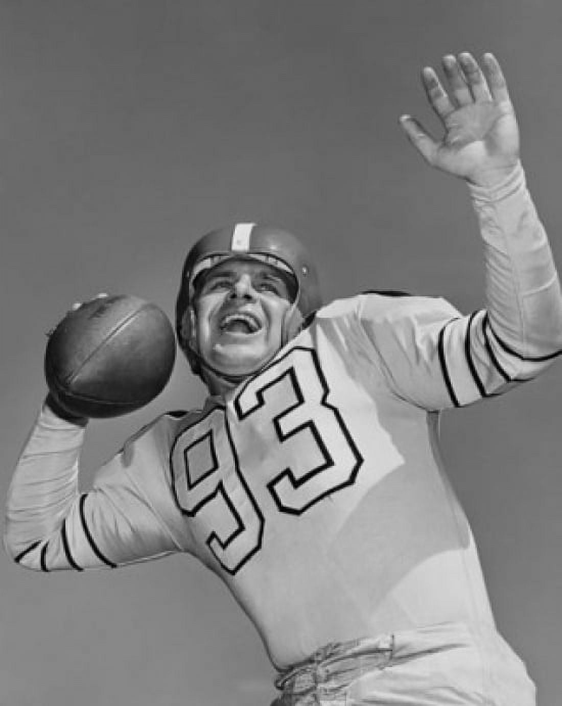 Low angle view of a football player throwing a football Canvas Art - (18 x 24)