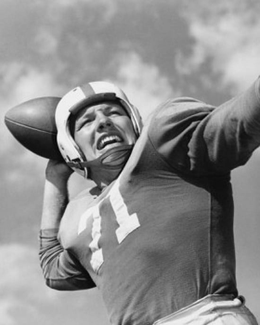 Low angle view of a football player throwing a football Canvas Art - (18 x 24)