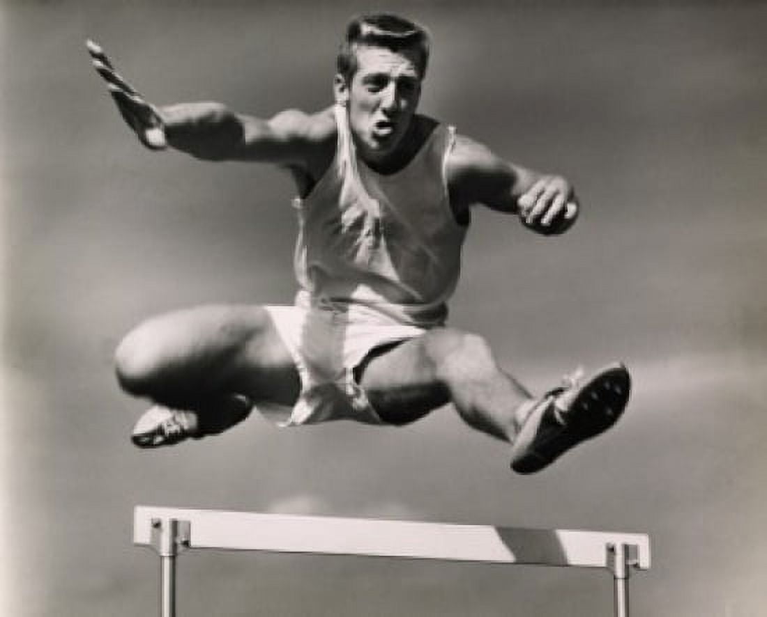 Low angle view of a male athlete jumping over a hurdle Canvas Art - (18 x 24)