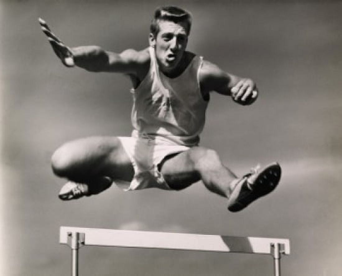 Low angle view of a male athlete jumping over a hurdle Canvas Art - (24 x 36)