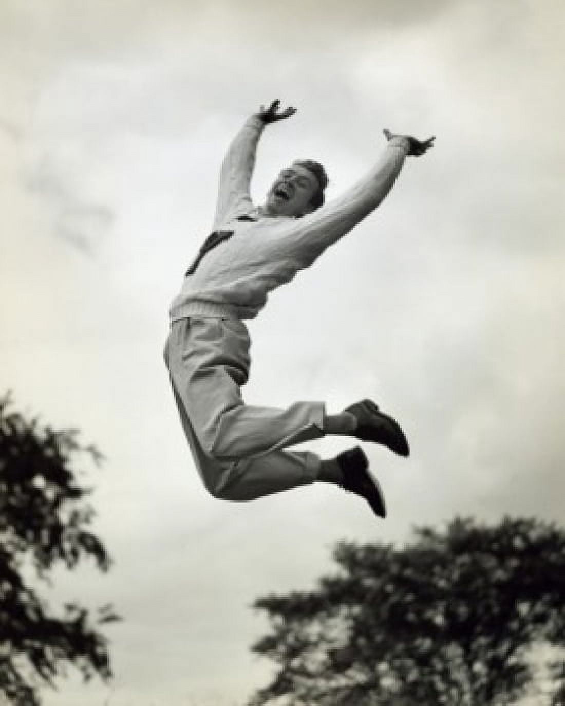 Low angle view of a male cheerleader jumping and cheering Canvas Art - (18 x 24)