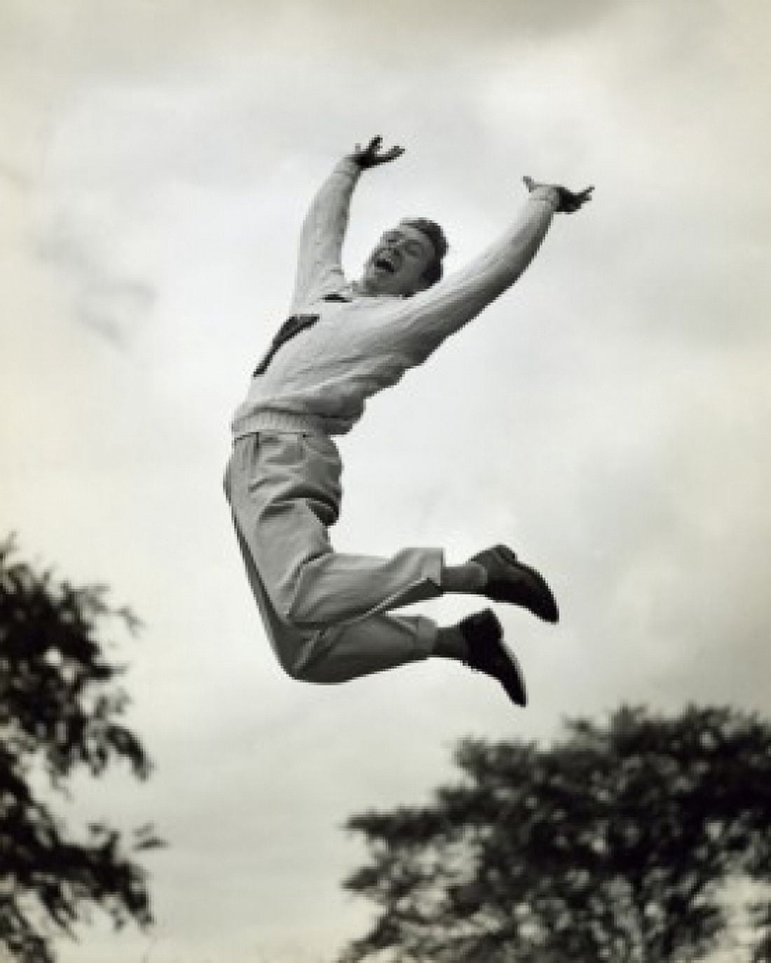 Low angle view of a male cheerleader jumping and cheering Canvas Art - (24 x 36)