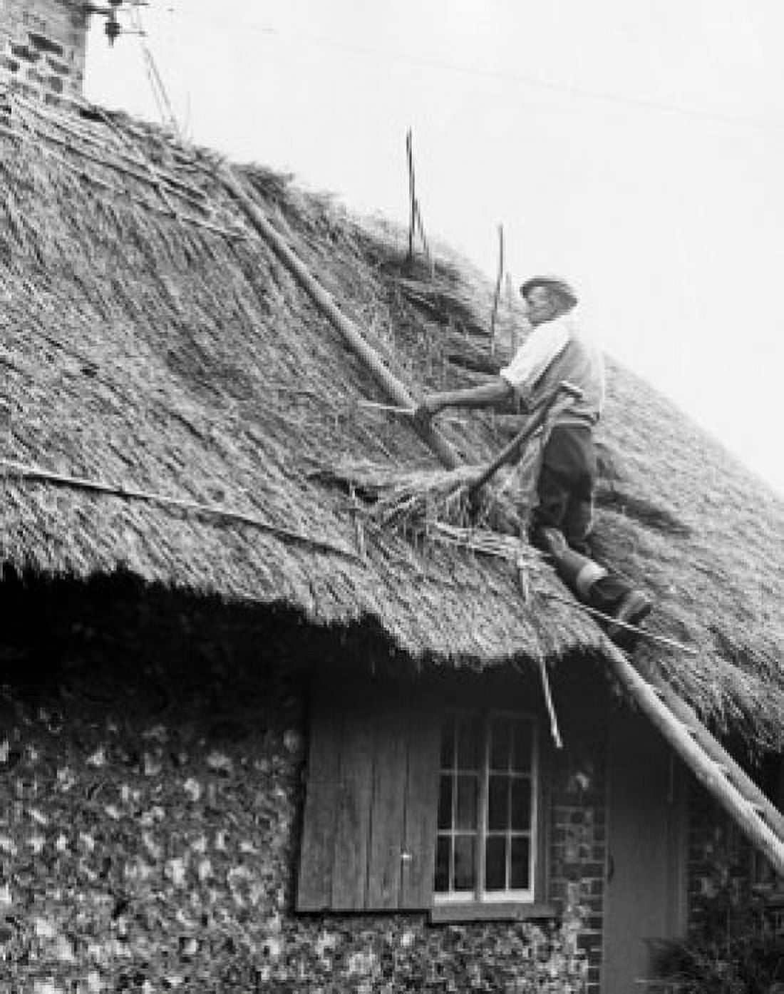Low angle view of a senior man thatching a roof Canvas Art - (18 x 24)