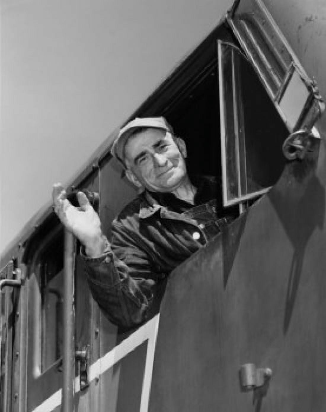 Low angle view of a train conductor smiling and waving Canvas Art - (24 x 36)