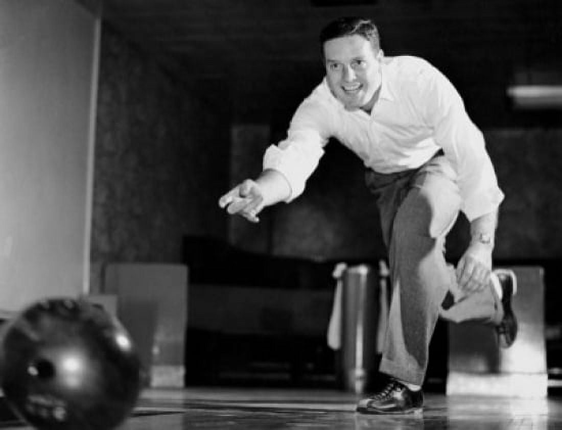 Low angle view of a young adult man bowling Canvas Art -  (24 x 36)