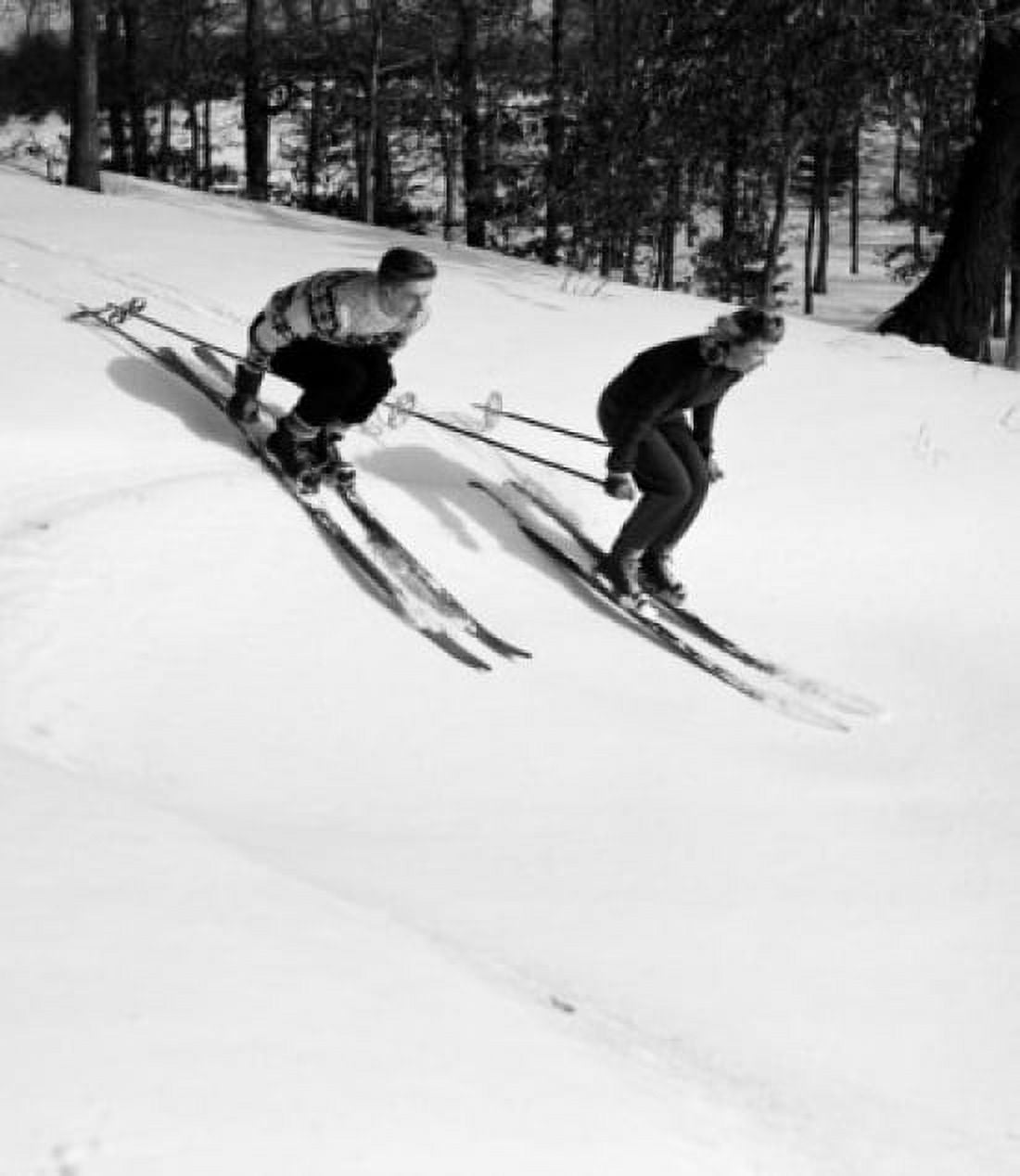 Low angle view of a young couple skiing downhill Canvas Art - (18 x 24)