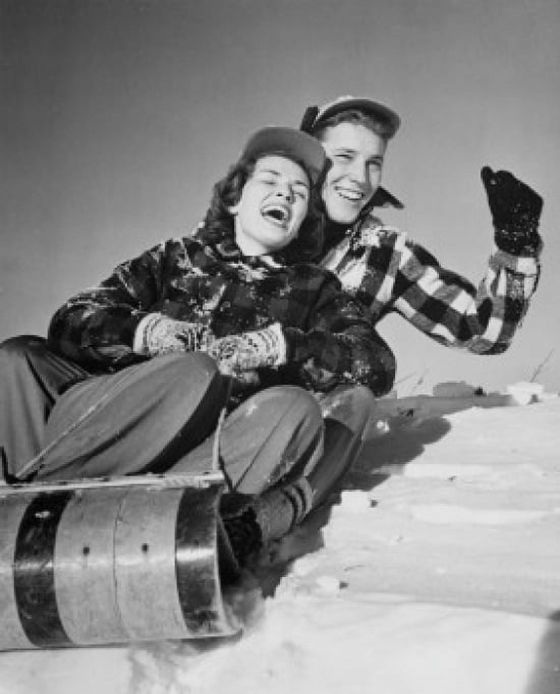 Low angle view of a young couple sliding on a sled Canvas Art - (24 x 36)