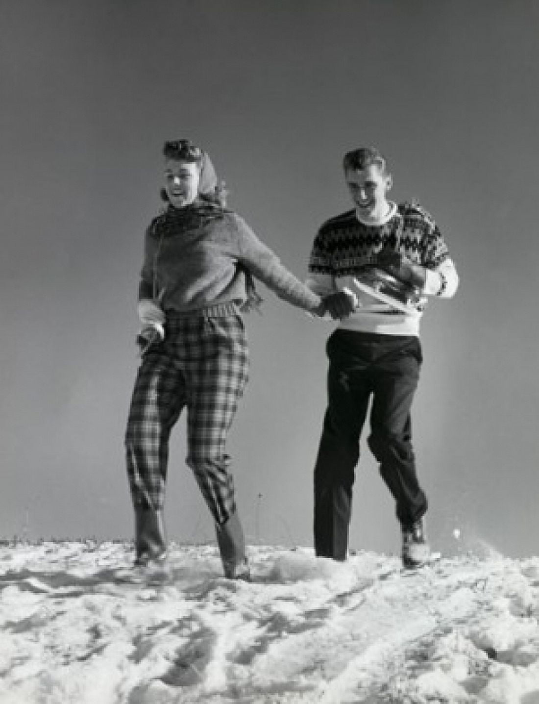 Low angle view of a young couple walking in snow Canvas Art - (18 x 24)