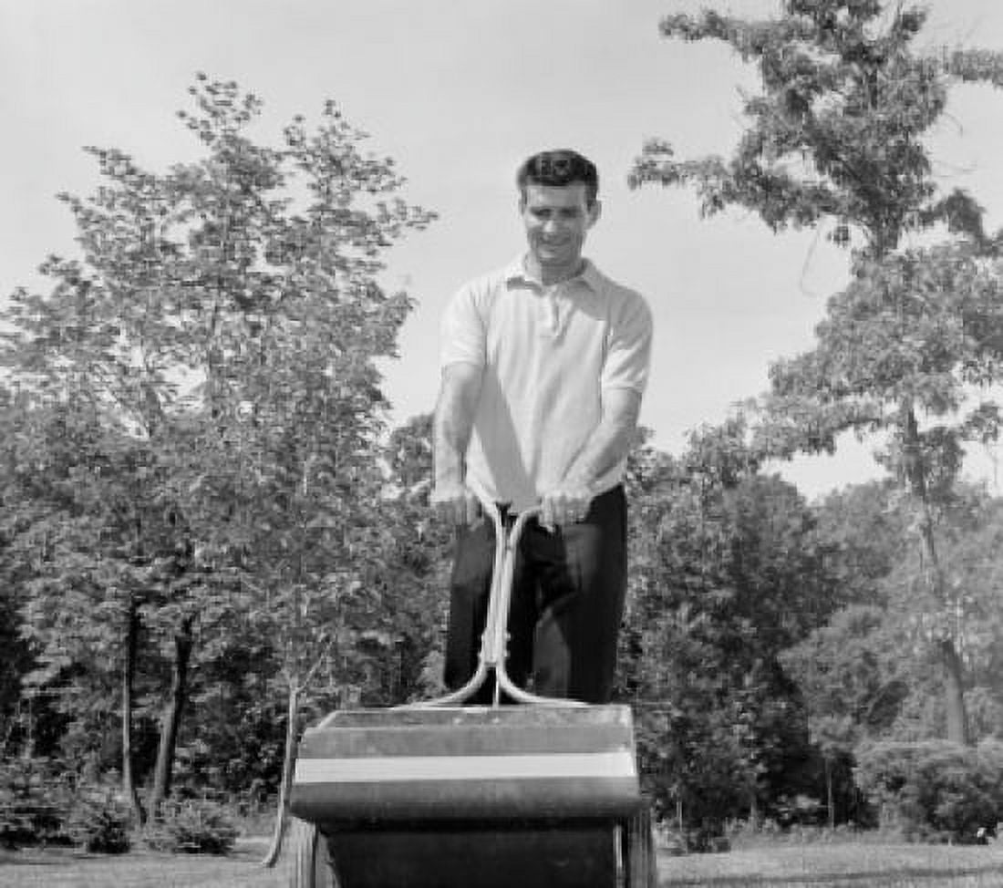 Low angle view of a young man fertilizing a lawn Canvas Art - (18 x 24)