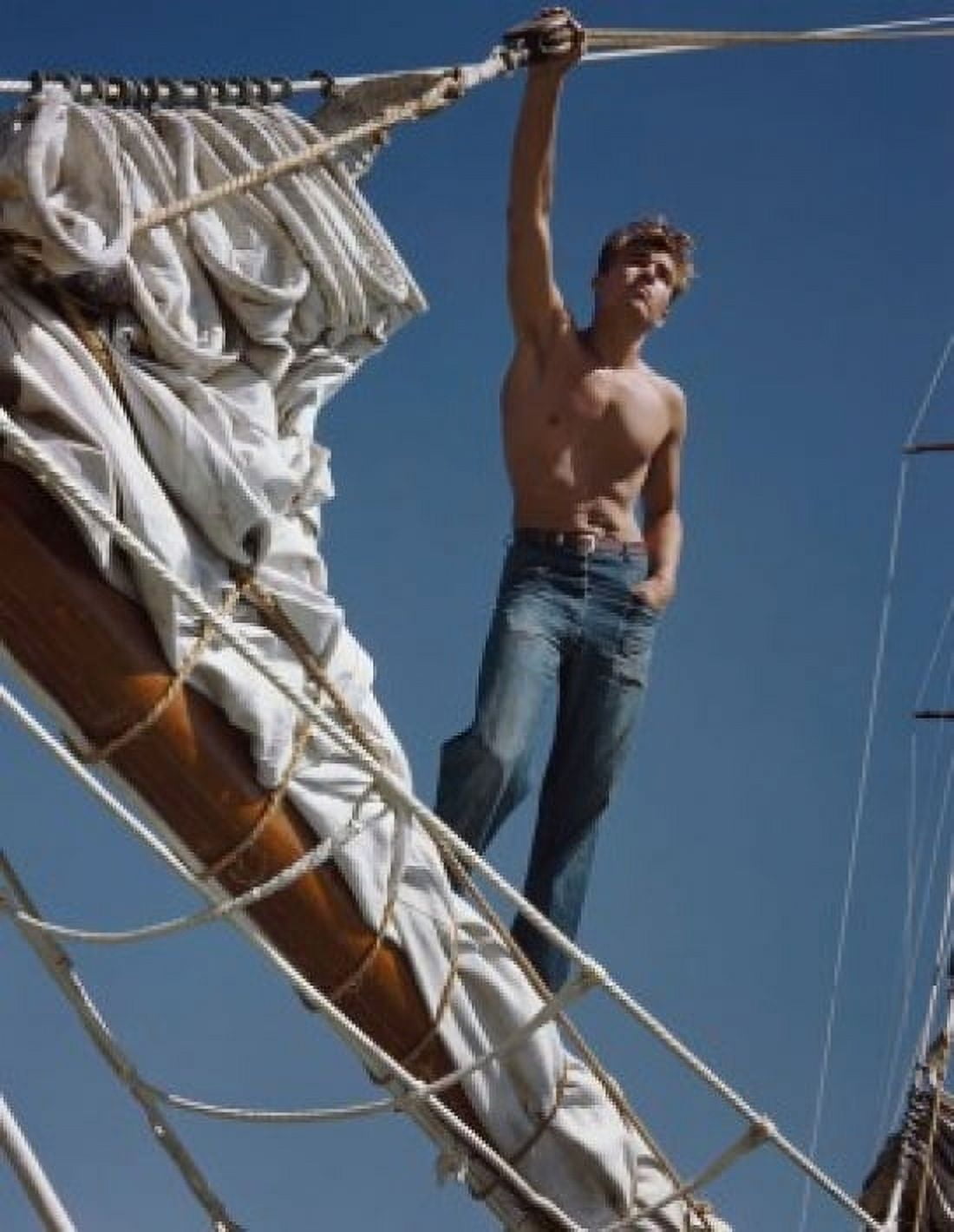 Low angle view of a young man standing on a pole on a sailing ship Canvas Art - (24 x 36)
