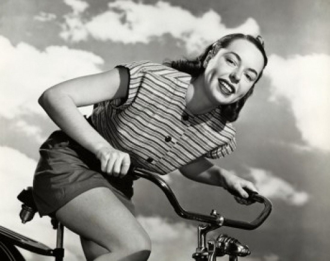 Low angle view of a young woman cycling Canvas Art - (24 x 36)