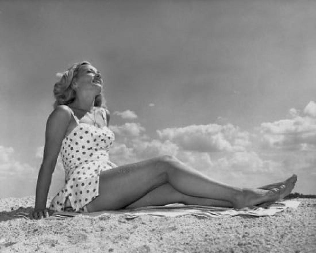 Low angle view of a young woman sunbathing on the beach Canvas Art - (24 x 36)