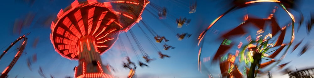 Low angle view of amusement park rides in motion Canvas Art - Panoramic Images (27 x 9)