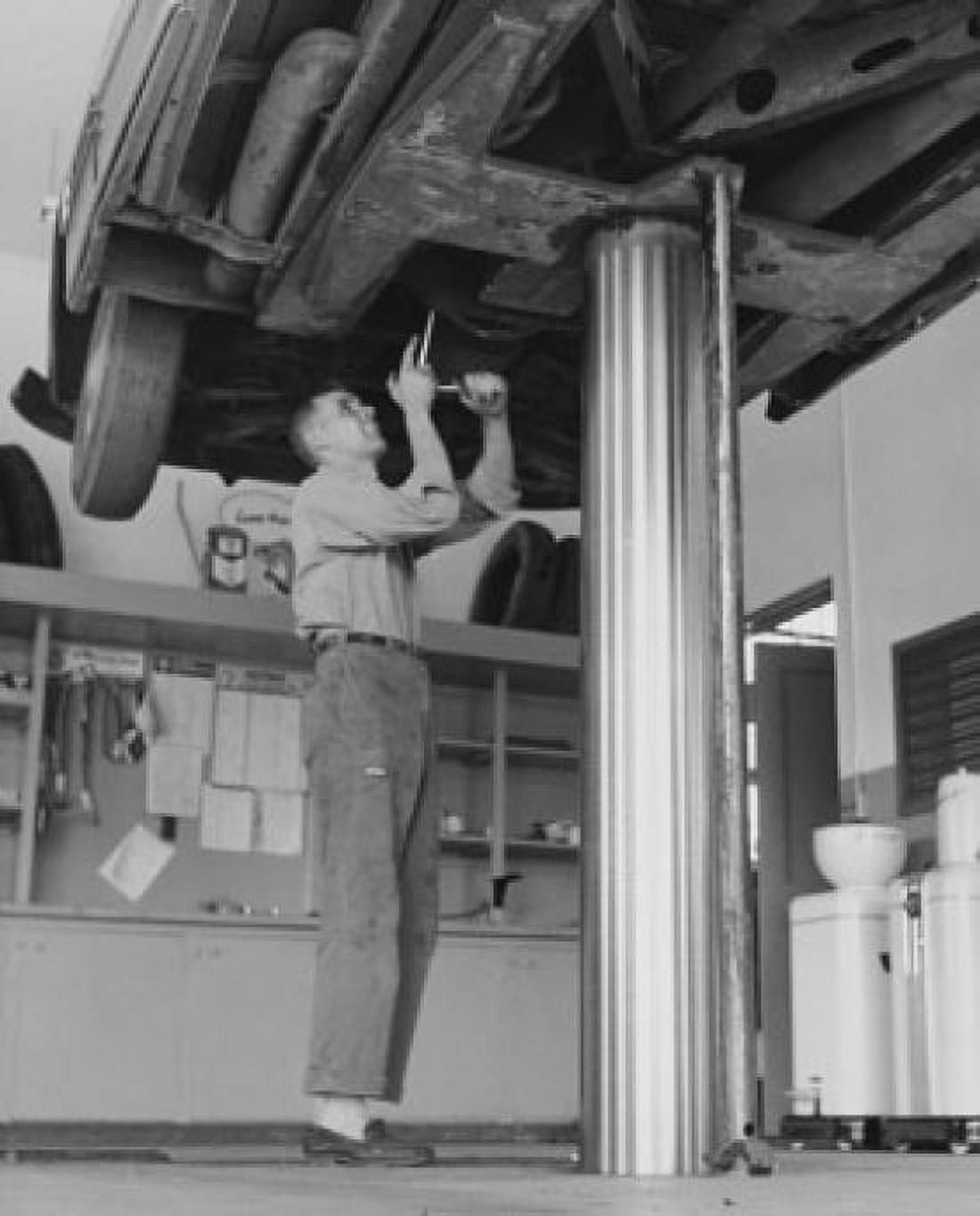 Low angle view of an auto mechanic repairing a car Canvas Art - (24 x 36)