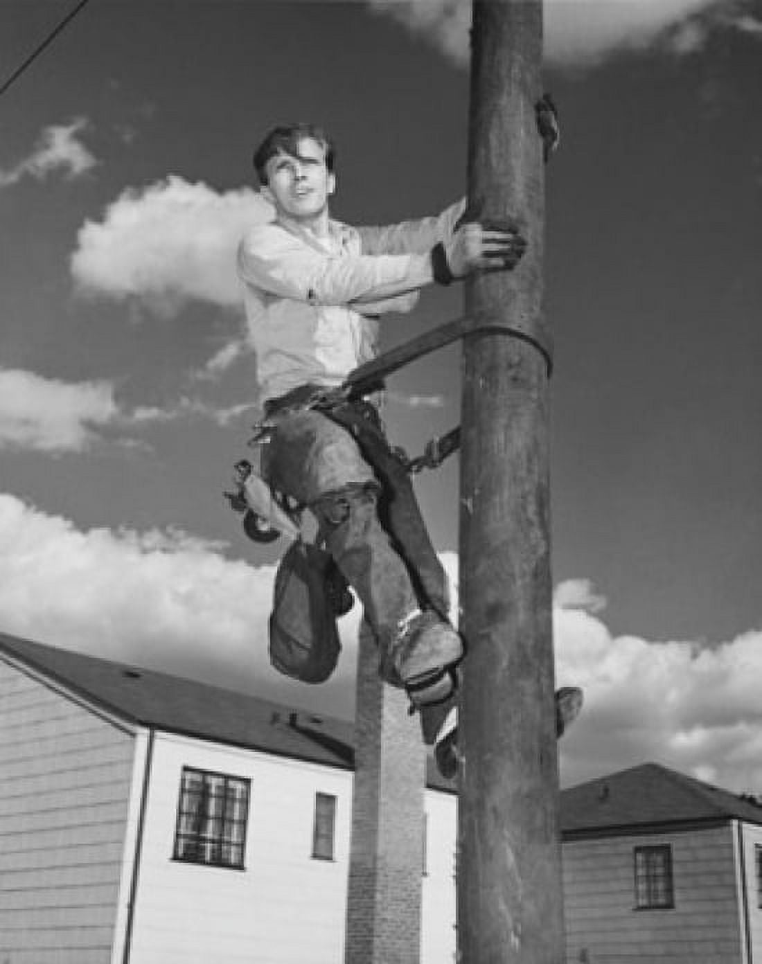 Low angle view of an electrician climbing on a pole Canvas Art - (24 x 36)