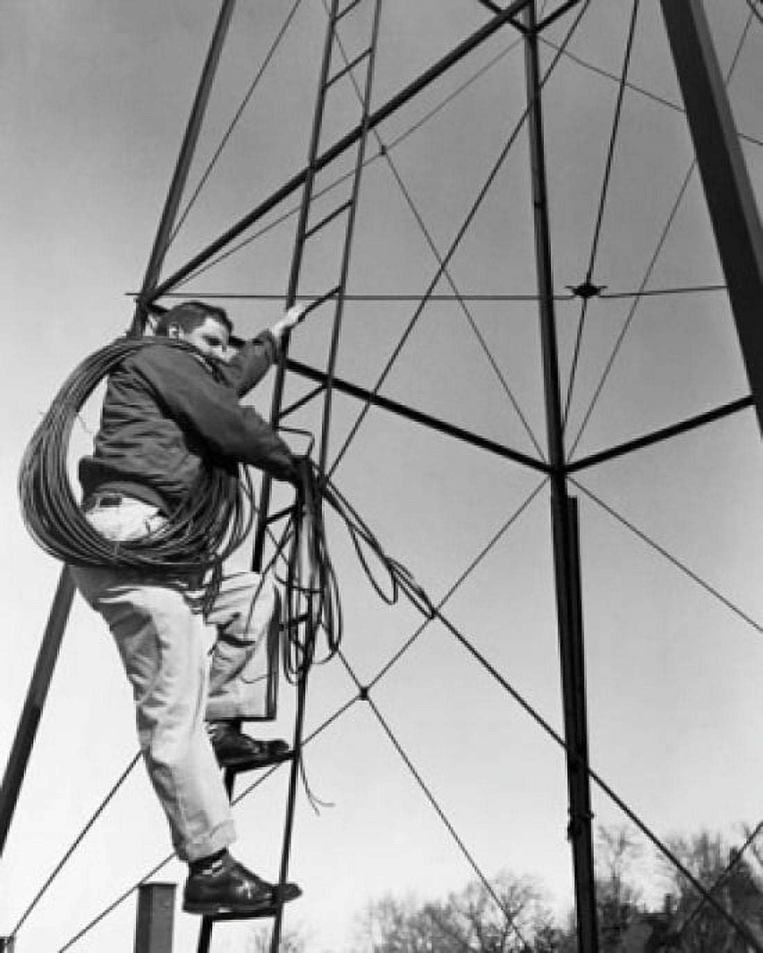 Low angle view of an electrician climbing on electricity pylon Canvas Art - (24 x 36)
