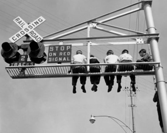 Low angle view of children sitting on a railroad crossing signal Canvas Art - (18 x 24)