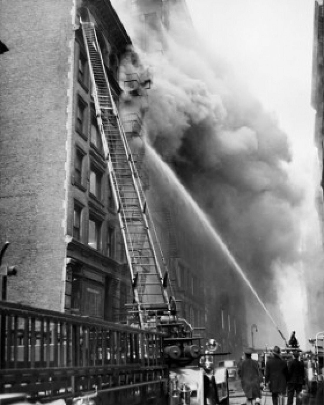 Low angle view of firemen spraying water on a burning building Canvas Art - (18 x 24)