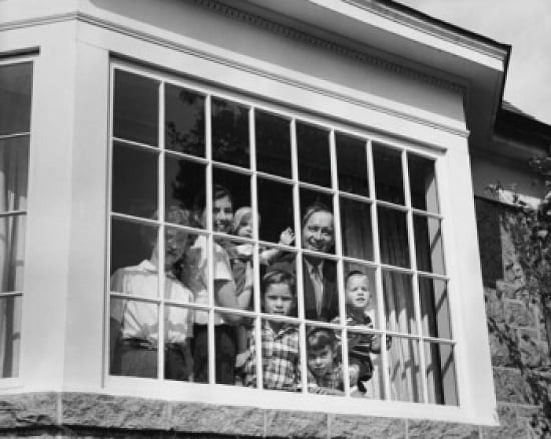 Low angle view of parents and their children looking through a window Canvas Art - (18 x 24)