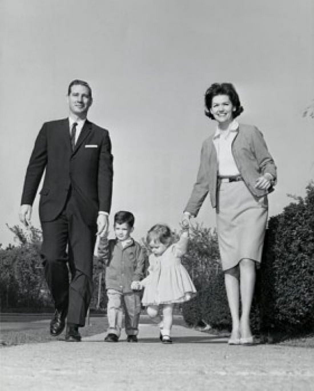 Low angle view of parents walking with children along path Canvas Art - (24 x 36)